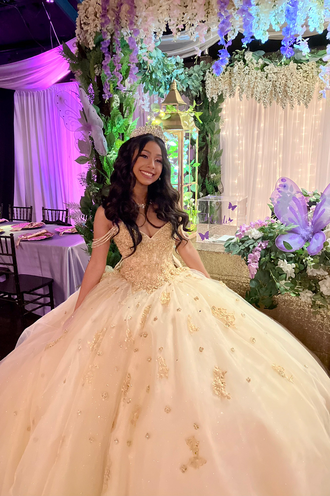Quinceañera girl in front of the garden gazebo.